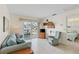 Cozy living room with sliding glass doors, tile floors, and comfortable blue furnishings at 902 Gibbs Rd # 282, Venice, FL 34285