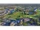 Aerial view of the golf course and tennis courts surrounded by lakes and trees at 9570 High Gate Dr # 1722, Sarasota, FL 34238