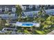 Aerial view highlighting the community pool, surrounded by palm trees and ample parking at 9570 High Gate Dr # 1722, Sarasota, FL 34238