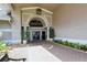 Elegant entrance to the community building featuring manicured landscaping and a welcoming ambiance at 9570 High Gate Dr # 1722, Sarasota, FL 34238