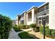 Charming condo exteriors feature screened in patios, manicured landscaping, and well-lit walkways at 9570 High Gate Dr # 1722, Sarasota, FL 34238