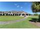 An exterior view of the clubhouse and surrounding greenery at 9570 High Gate Dr # 1722, Sarasota, FL 34238