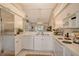 Well-lit kitchen featuring white appliances, cabinets, and an open layout with sightlines to the living area at 9570 High Gate Dr # 1722, Sarasota, FL 34238