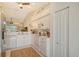 Bright kitchen with white cabinets, appliances, and a view into the living room, creating an open and airy space at 9570 High Gate Dr # 1722, Sarasota, FL 34238