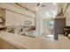 Bright kitchen features light cabinets and a pass-through to the balcony at 9570 High Gate Dr # 1722, Sarasota, FL 34238