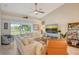 Bright and airy living room with comfortable sofas, stylish decor, and a beautiful view of the outdoors at 9570 High Gate Dr # 1722, Sarasota, FL 34238