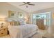 Cozy bedroom featuring a bay window, neutral decor, and plush bedding for a relaxing retreat at 9570 High Gate Dr # 1722, Sarasota, FL 34238
