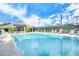 Inviting community pool and clubhouse with lounge chairs on the deck at 9570 High Gate Dr # 1722, Sarasota, FL 34238