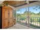 Bright sunroom with wooden ceilings, and expansive views of the golf course at 9570 High Gate Dr # 1722, Sarasota, FL 34238