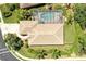 Aerial view of backyard featuring a screened-in pool and beautiful landscaping around the home at 9734 51St Terr E, Bradenton, FL 34211