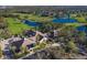 High-angle view of Rosedale Golf and Country Club showcasing the clubhouse, golf course, and tranquil water features at 9734 51St Terr E, Bradenton, FL 34211