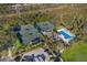 Aerial view showcases community pool, tennis courts, landscaping, and nearby parking at 9734 51St Terr E, Bradenton, FL 34211