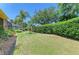 Beautiful backyard with lush green lawn, privacy hedges, and tropical landscaping at 9734 51St Terr E, Bradenton, FL 34211