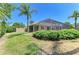 Landscaped backyard with a screened-in pool enclosure and well-manicured lawn at 9734 51St Terr E, Bradenton, FL 34211