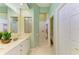 Bathroom featuring double vanity, glass block window, and walk-in shower and toilet at 9734 51St Terr E, Bradenton, FL 34211