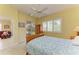 Bedroom with a wooden armoire, plantation shutters, and view of screened lanai at 9734 51St Terr E, Bradenton, FL 34211