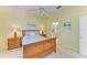Comfortable bedroom with a wooden sleigh bed, neutral walls, and ensuite bathroom at 9734 51St Terr E, Bradenton, FL 34211