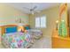 Bright bedroom featuring two twin beds, plantation shutters, and neutral walls at 9734 51St Terr E, Bradenton, FL 34211