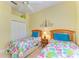 Bedroom featuring two twin beds, neutral walls, and a ceiling fan at 9734 51St Terr E, Bradenton, FL 34211