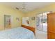 Bedroom with ensuite bathroom and sliding glass doors leading to screened lanai at 9734 51St Terr E, Bradenton, FL 34211