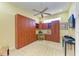 This bedroom features a unique Murphy bed, built-in desk, cabinets, and a ceiling fan for added comfort and convenience at 9734 51St Terr E, Bradenton, FL 34211