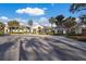 Front exterior view of the Rosedale Golf and Country Club clubhouse showcasing palm trees and manicured landscape at 9734 51St Terr E, Bradenton, FL 34211