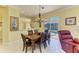 The dining area has natural light and opens to the pool area, seamlessly blending indoor and outdoor living at 9734 51St Terr E, Bradenton, FL 34211