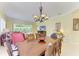 Open dining room featuring a decorative chandelier and seamless access to the living area at 9734 51St Terr E, Bradenton, FL 34211