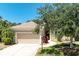 Lovely home with a well-manicured lawn, tall palms, and a two-car garage providing ample parking at 9734 51St Terr E, Bradenton, FL 34211