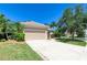 Charming one-story home with a two-car garage and a well-maintained lawn and mature trees at 9734 51St Terr E, Bradenton, FL 34211