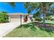 Well-maintained front yard with mature trees, a lamp post, and lush green grass creating a welcoming entrance at 9734 51St Terr E, Bradenton, FL 34211