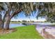 Scenic view of a golf course with a bridge, lake and mature trees at 9734 51St Terr E, Bradenton, FL 34211