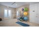 Yoga and stretching area with fitness balls, mats, and wood-look accent wall at 9734 51St Terr E, Bradenton, FL 34211