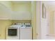 This laundry room features matching, modern washer and dryer units along with above-appliance storage cabinets at 9734 51St Terr E, Bradenton, FL 34211