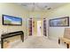 Bright room featuring an entertainment center with a wall-mounted TV and french doors leading to another part of the house at 9734 51St Terr E, Bradenton, FL 34211