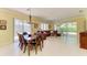 Open-concept living space with elegant dining area, and ample natural light from sliding glass doors at 9734 51St Terr E, Bradenton, FL 34211