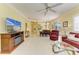 Spacious living area showcasing comfortable seating, a modern fireplace, and an open layout at 9734 51St Terr E, Bradenton, FL 34211