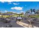 Beautiful outdoor patio seating area with umbrellas and string lights overlooking the lawn at 9734 51St Terr E, Bradenton, FL 34211