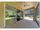 Covered patio features a fan, sliding glass doors and view of the screened-in pool at 9734 51St Terr E, Bradenton, FL 34211