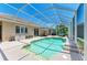 Lovely screened-in pool features a waterfall and ample lounging space at 9734 51St Terr E, Bradenton, FL 34211