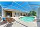 Screened-in pool with seating, dining area and well-kept deck at 9734 51St Terr E, Bradenton, FL 34211