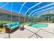 The screen-enclosed pool area includes comfortable seating and a small waterfall at 9734 51St Terr E, Bradenton, FL 34211