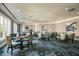 Bright sitting area with modern decor, large windows and tables for gathering or activities at 9734 51St Terr E, Bradenton, FL 34211