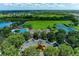 Aerial view showcasing the community clubhouse, pool, tennis courts, and green spaces at 9767 50Th Street E Cir, Parrish, FL 34219