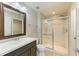 Bathroom features a glass enclosed shower, and dark wood vanity at 9767 50Th Street E Cir, Parrish, FL 34219