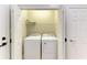 Laundry room features white washer and dryer units, and a wire rack at 9767 50Th Street E Cir, Parrish, FL 34219