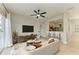 Bright living room features modern decor, tile floors, a ceiling fan and sliding glass doors to the outdoor patio at 9767 50Th Street E Cir, Parrish, FL 34219