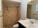 Bathroom with tiled shower, basin sink and vanity at 1036 Hope St, Venice, FL 34285