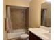 Clean bathroom with shower-tub combination, tiled walls, and vanity sink at 1036 Hope St, Venice, FL 34285