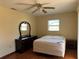 Bright bedroom with ceiling fan, wood flooring, and dark wood furniture at 1036 Hope St, Venice, FL 34285